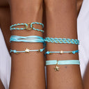 Close-up of a person's wrist wearing multiple turquoise bracelets with gold accents on a white background.