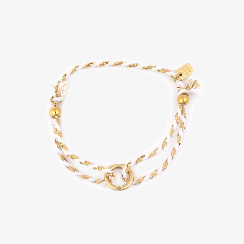 Gold bracelet with white cord on a white background